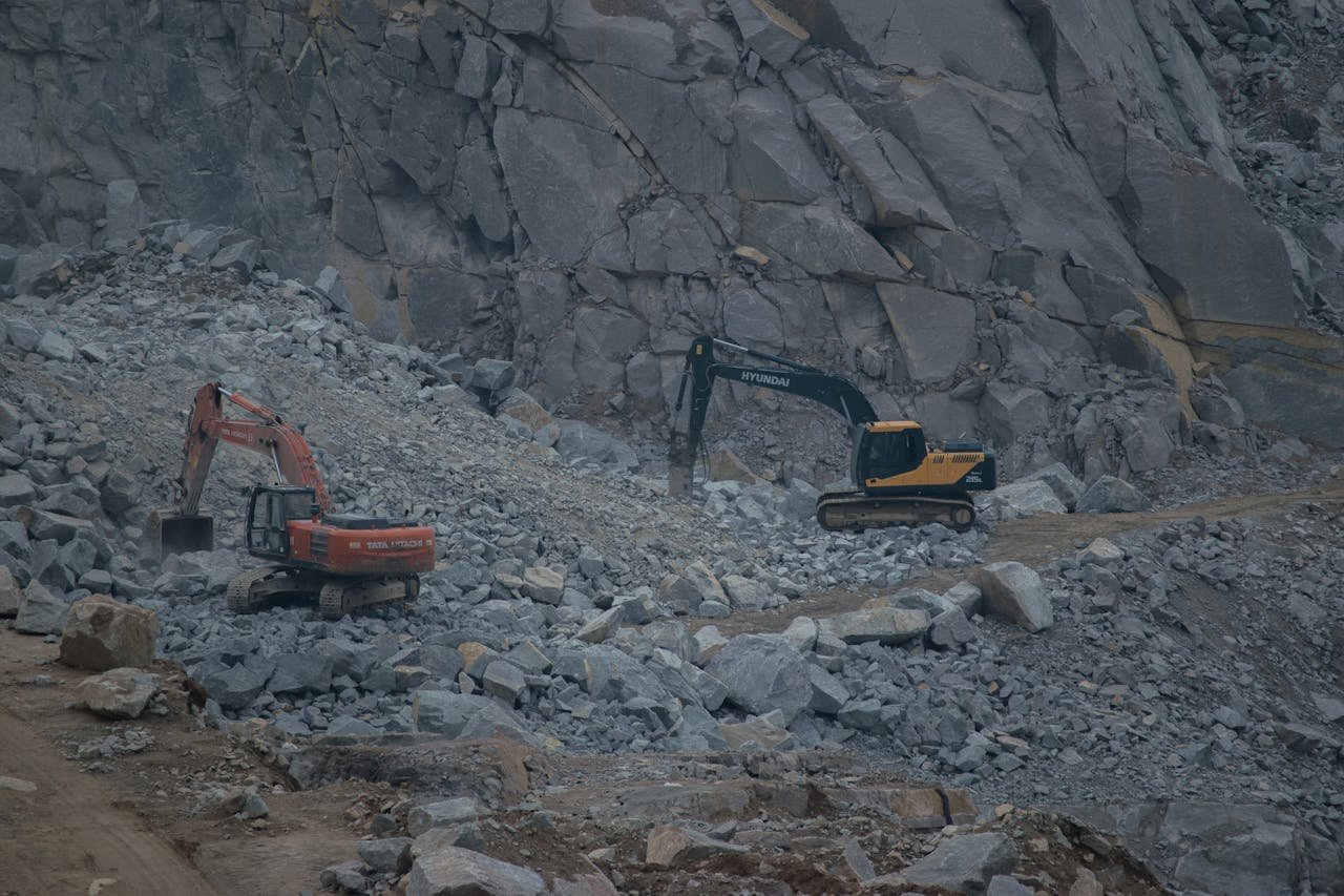 Crafting Captivating Headlines: Your awesome post title goes here Dynamic construction site featuring excavators working on rocky terrain.