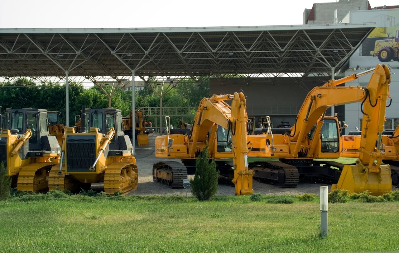 Home Heavy-duty construction machinery displayed outdoors, include excavators and bulldozers.